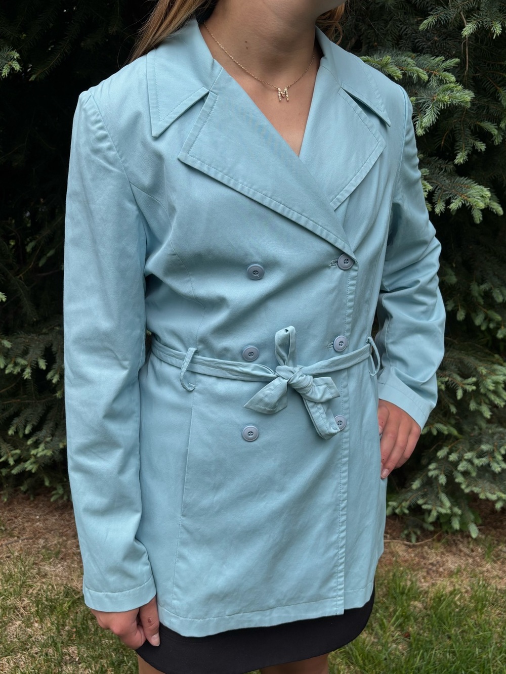 Light blue trench coat double-breasted button closure and a tie waist